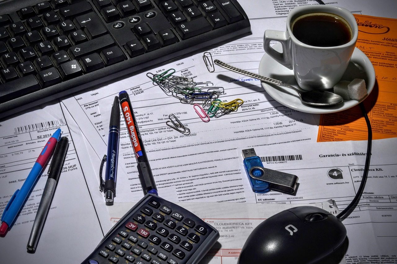 Coffee, a calculator and a stack of paperwork