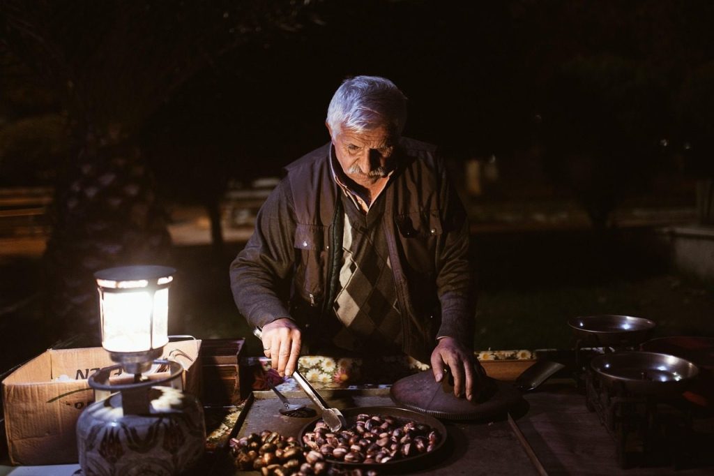 A stallholder working by lantern light