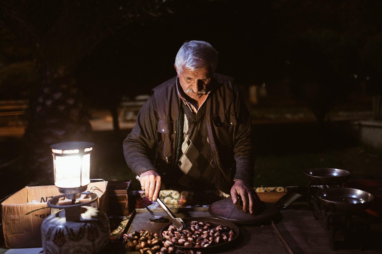 A stallholder working by lantern light