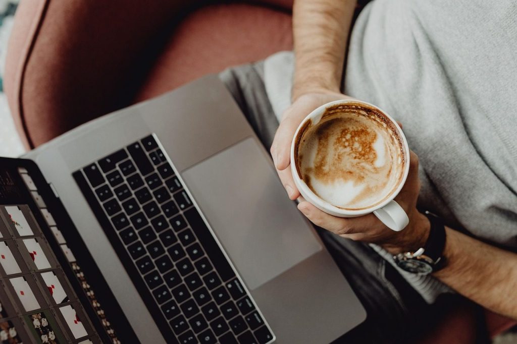 A laptop and a cup of coffee mid-morning
