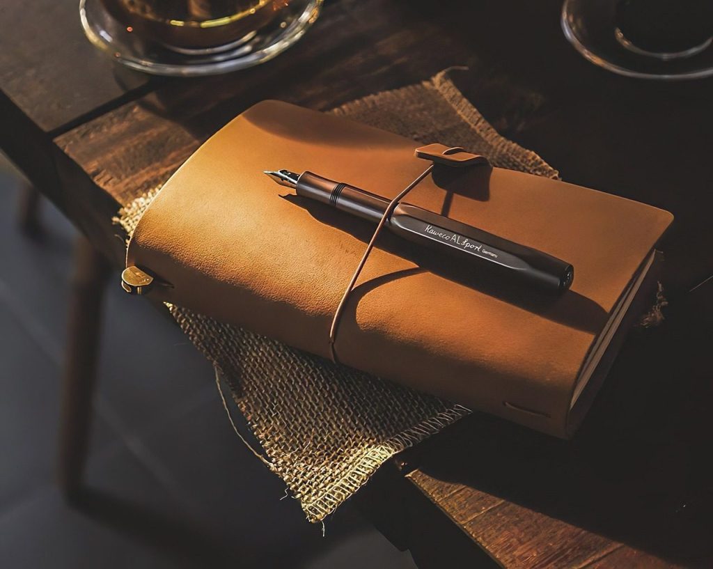 A leather notebook closed on a dark table