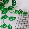 Artistic close-up of lush Monstera leaves with a grid pattern in the background