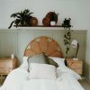 A serene bedroom with natural elements, featuring cozy bedding and indoor plants