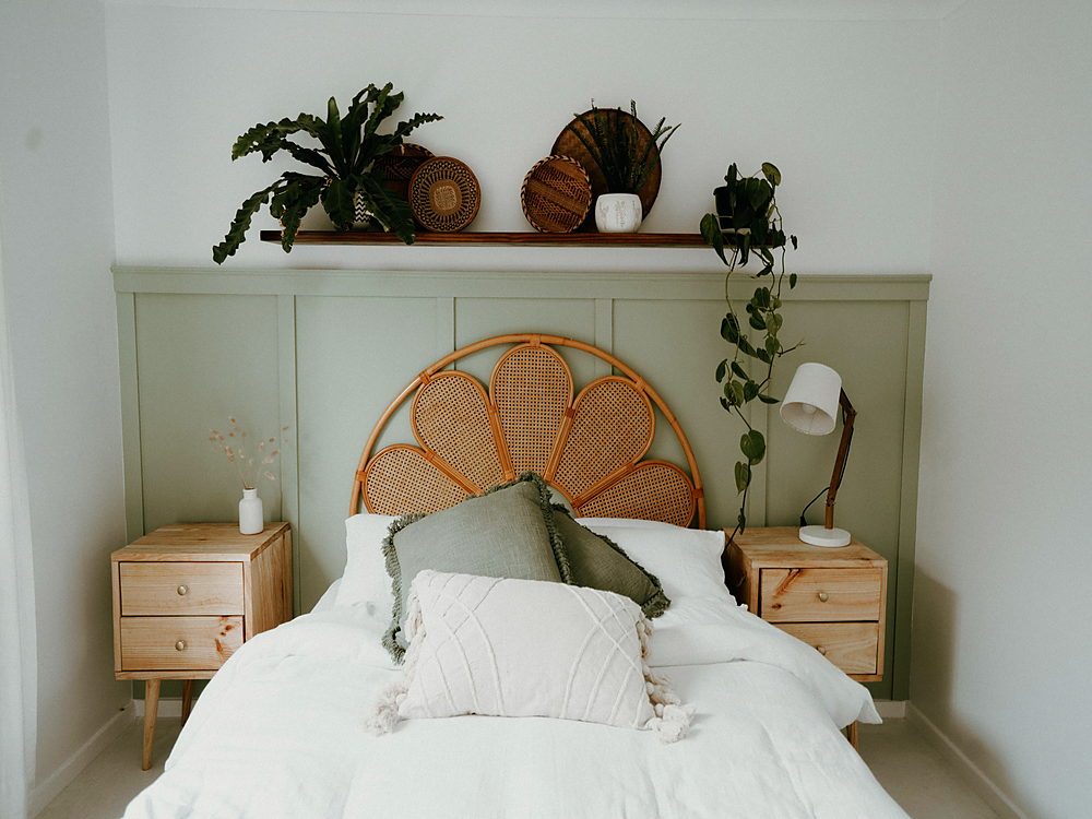 A serene bedroom with natural elements, featuring cozy bedding and indoor plants